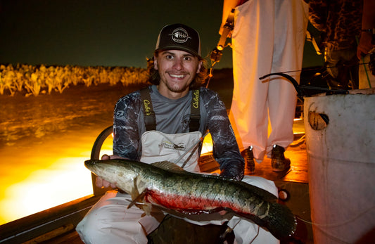 Max Wadlington bowfishing sneakheads with bowfishing arrow